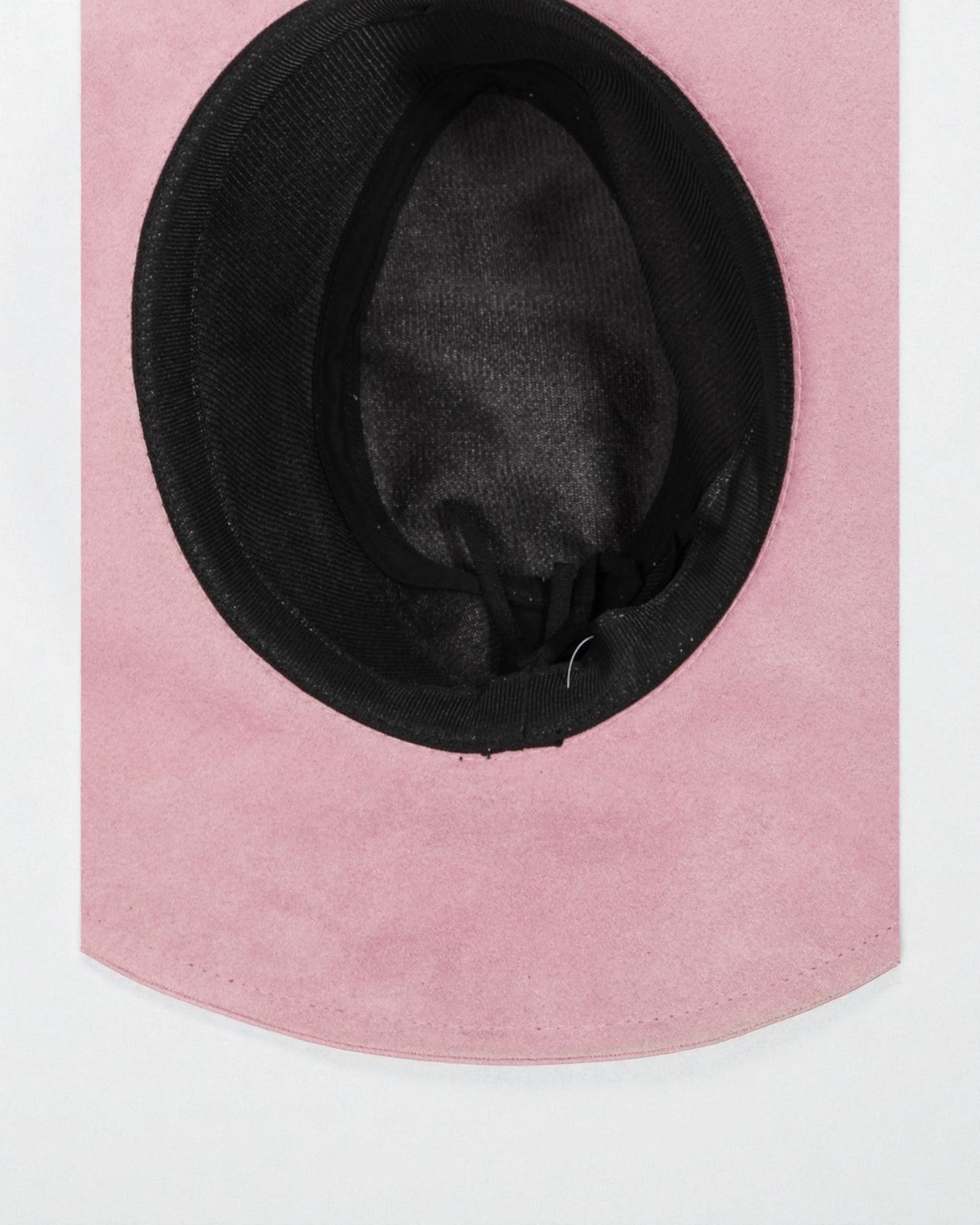 Pink hat with black interior on a pink background