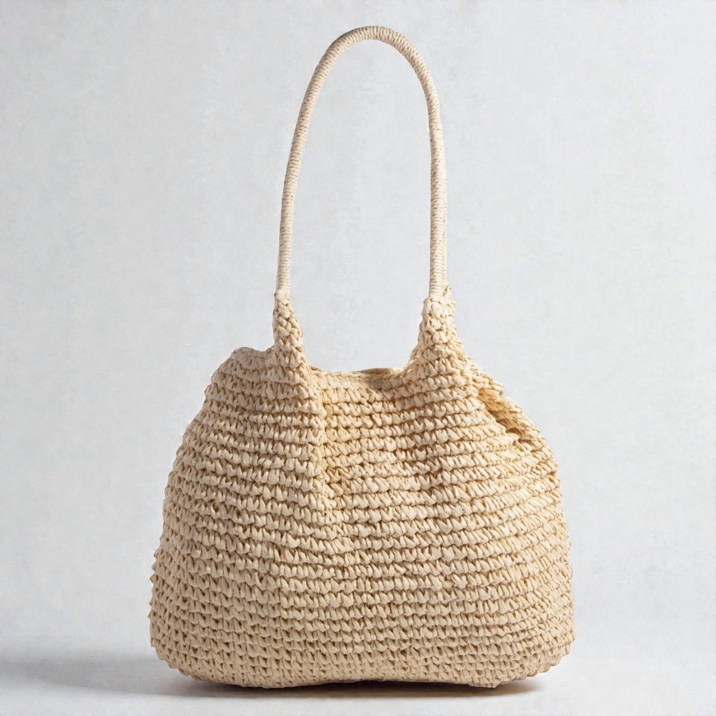 Beige woven handbag on a light gray background