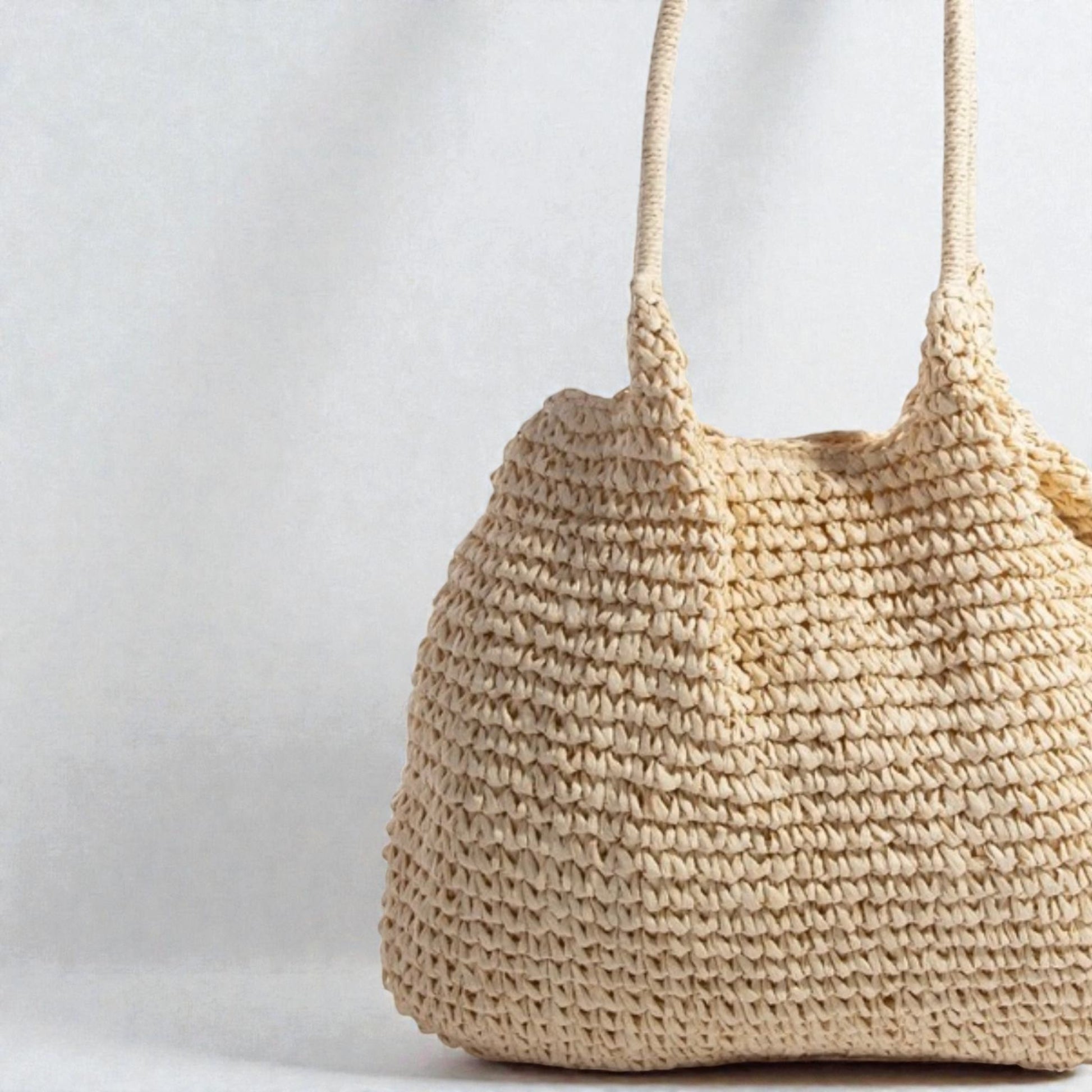 Beige woven handbag on a light gray background