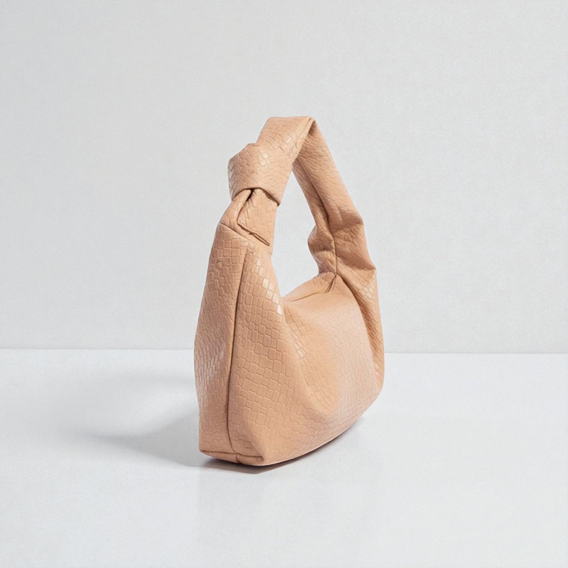 Beige handbag on a light gray background