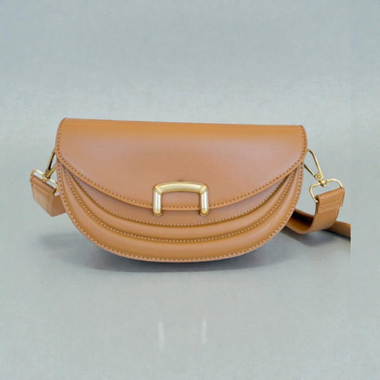 Tan handbag with gold accents on a light gray background