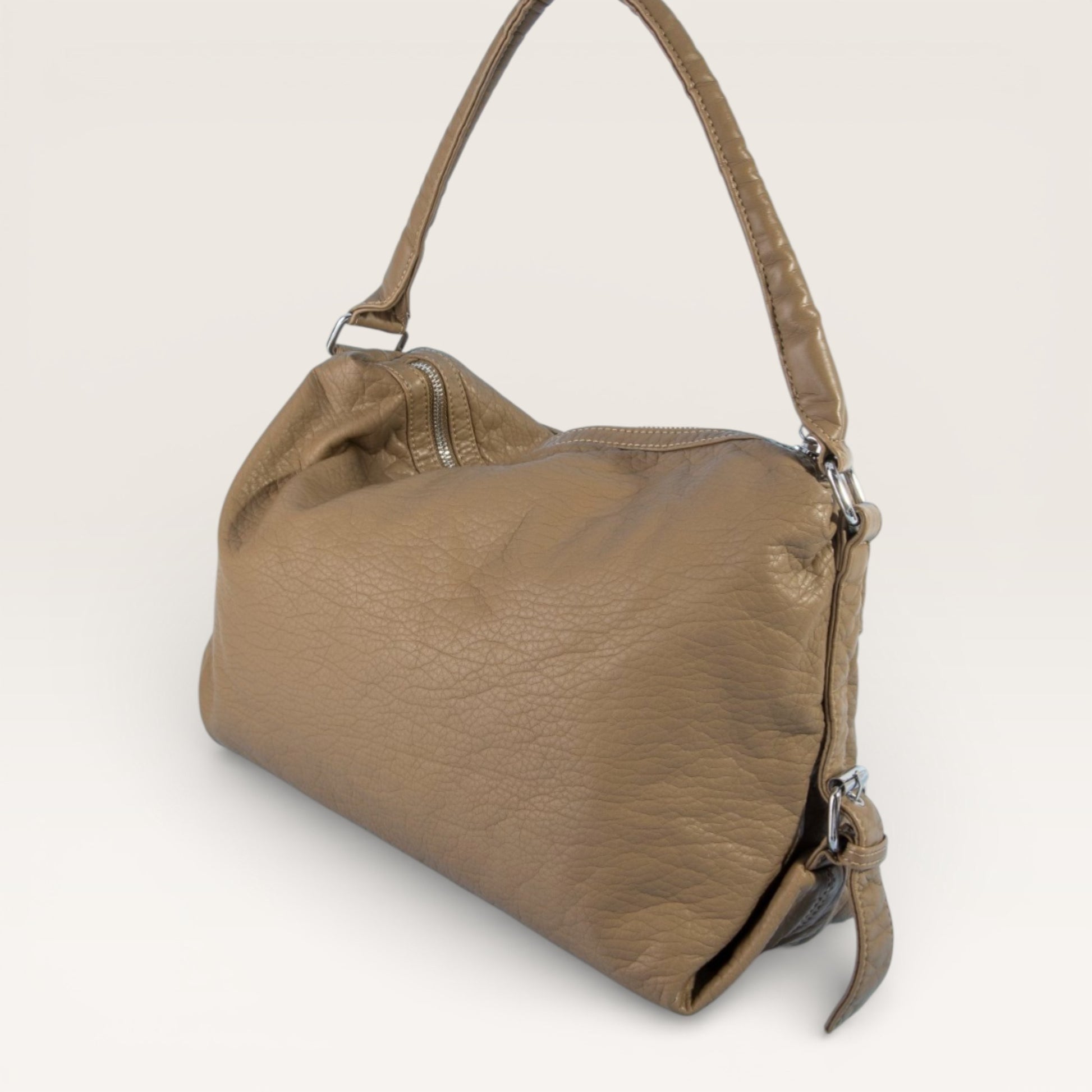 Brown leather handbag on a light gray background