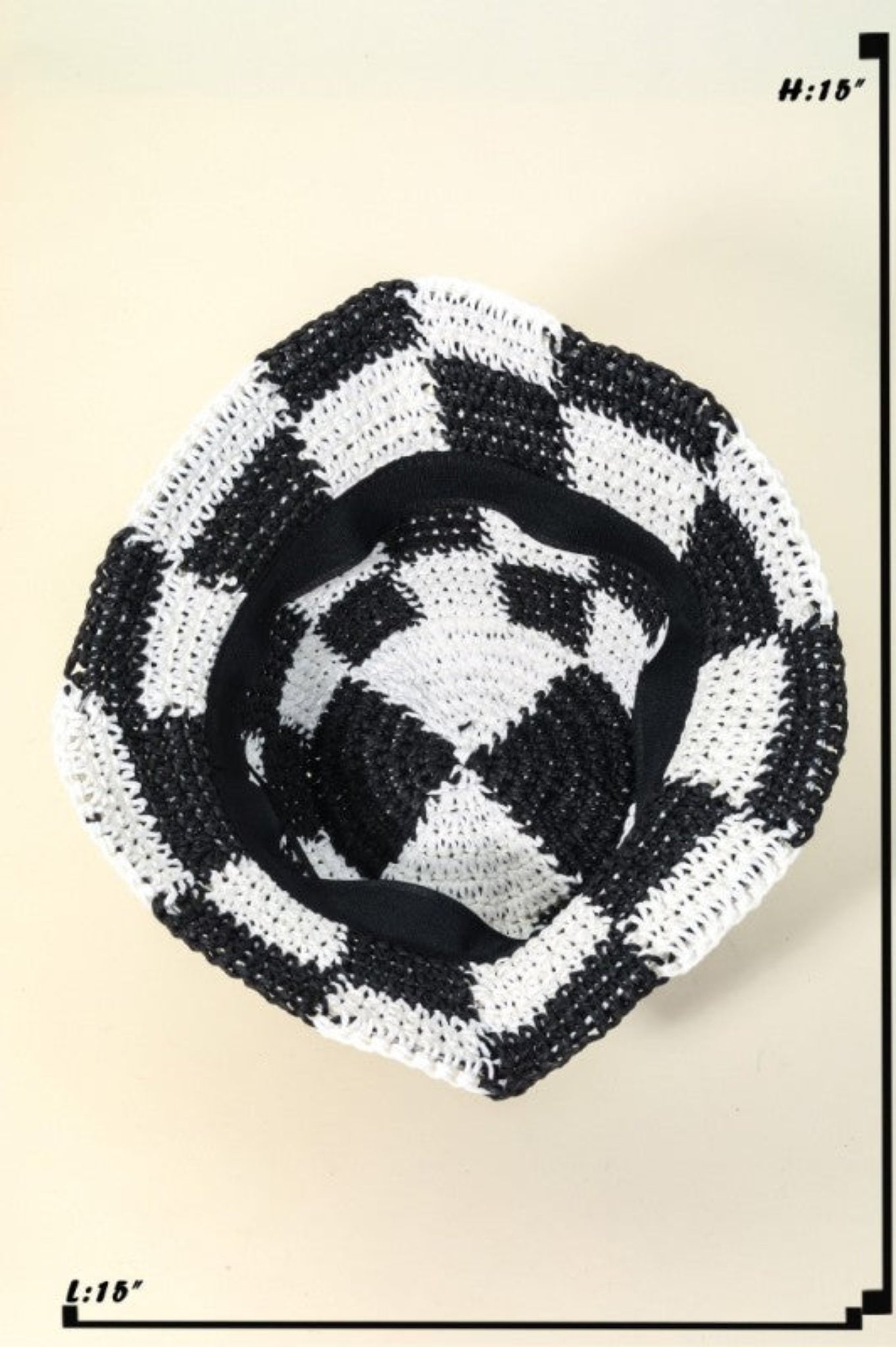 Black and white checkered woven basket on a beige background