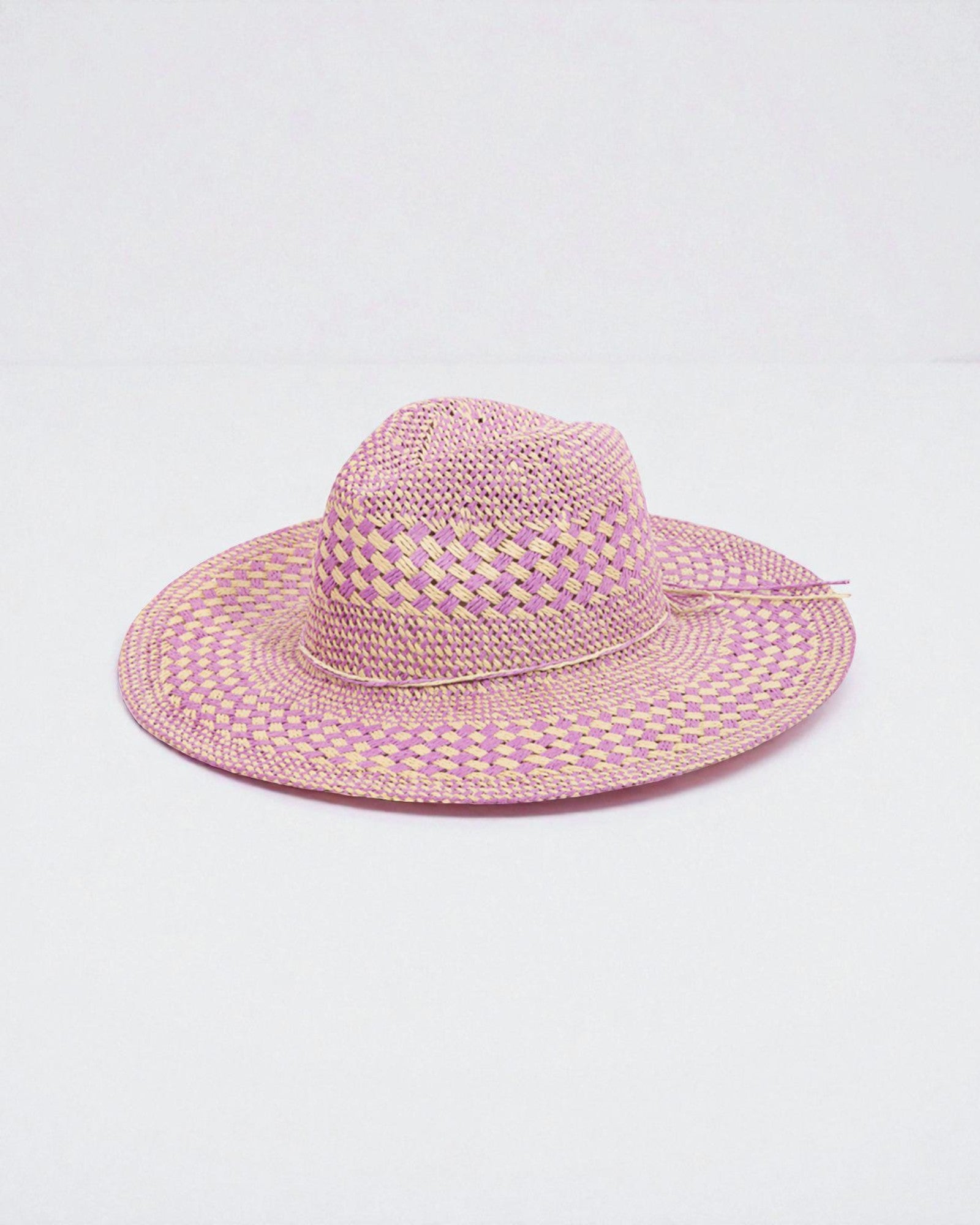 Pink straw hat on a light gray background