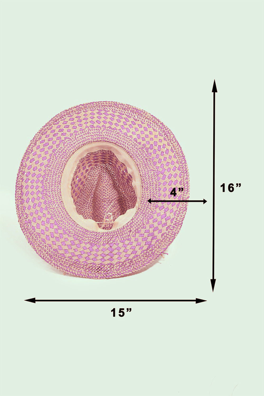 Pink straw hat with measurements on a light green background