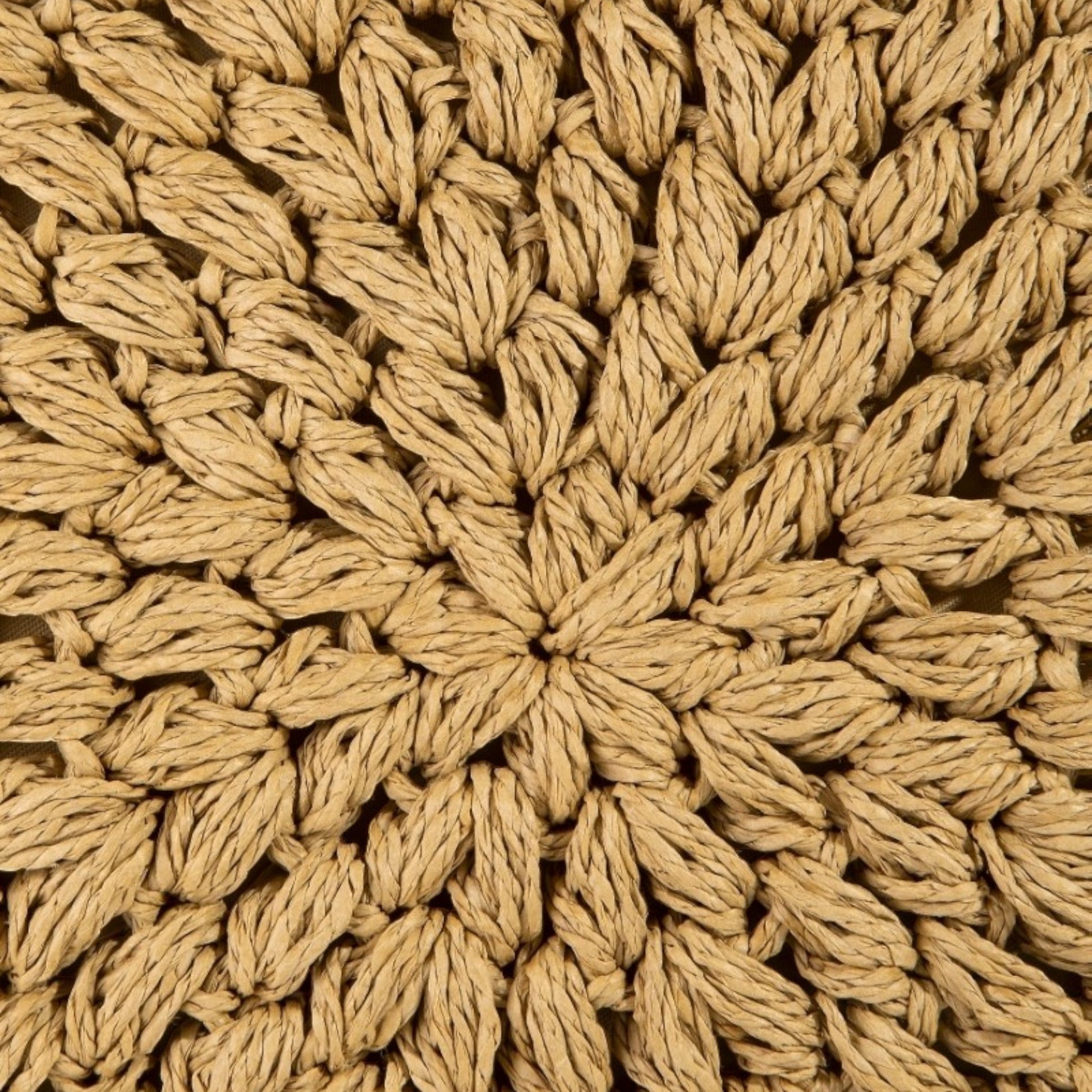 Close-up of a textured beige fabric with a starburst pattern