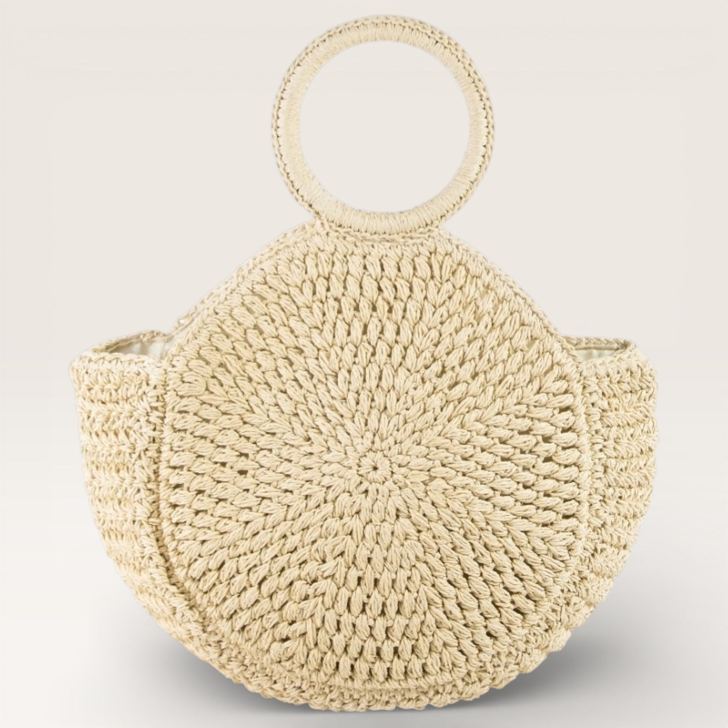 Beige woven handbag with round handles on a light gray background