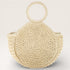 Beige woven handbag with round handles on a light gray background