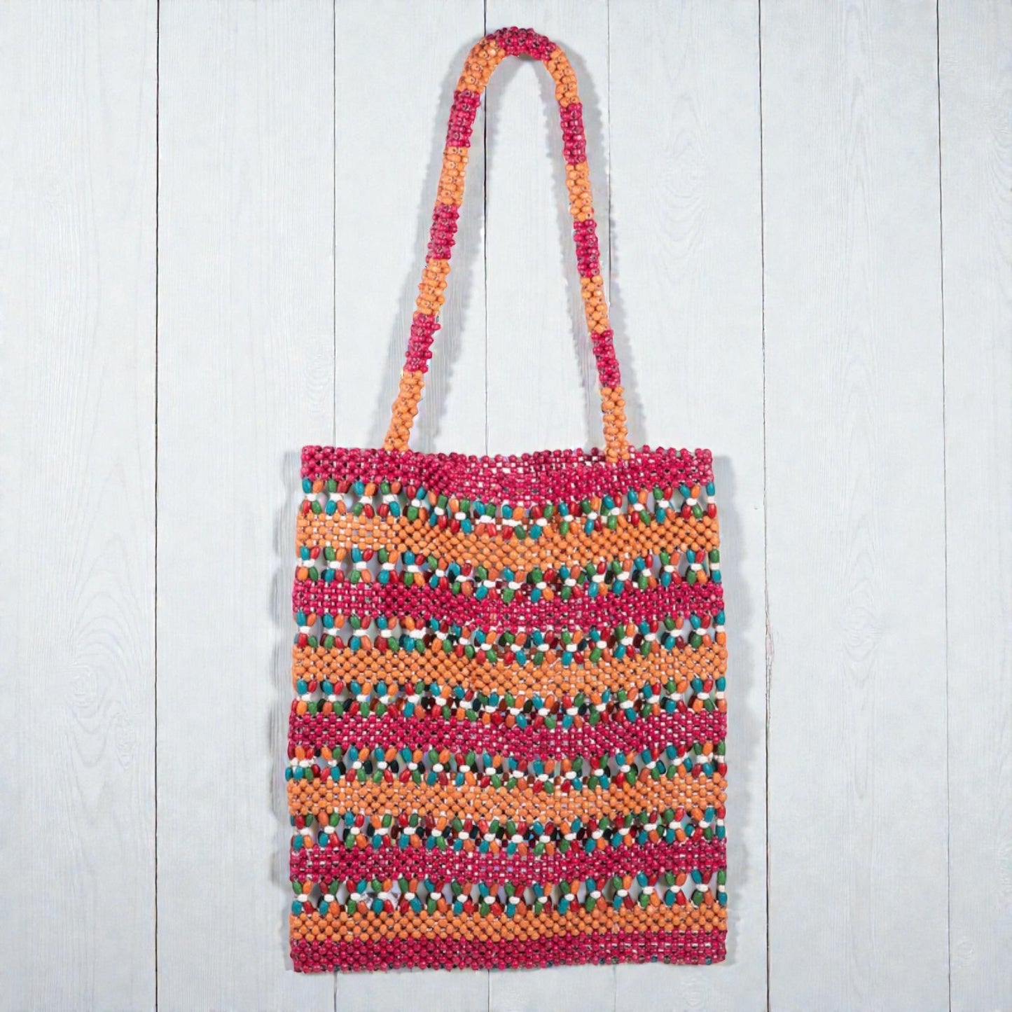 Colorful woven bag with a striped pattern on a white wooden surface