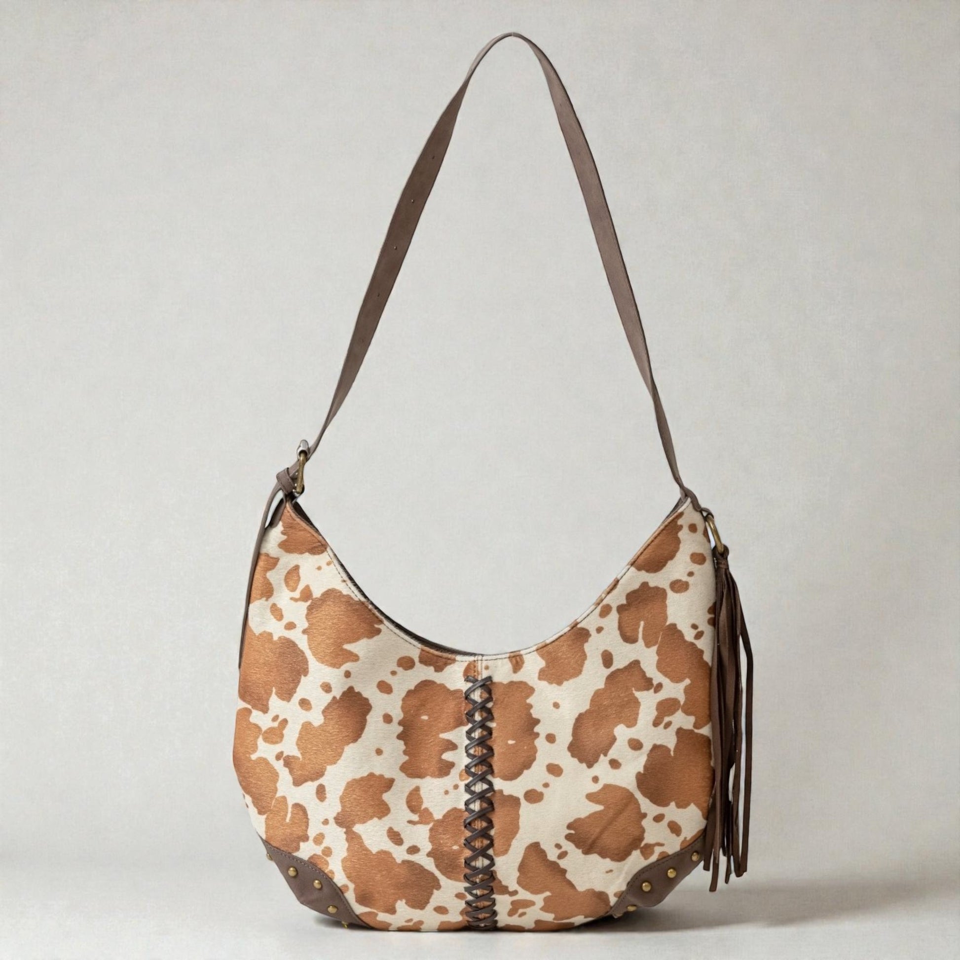 Brown and beige patterned handbag with a strap on a light gray background