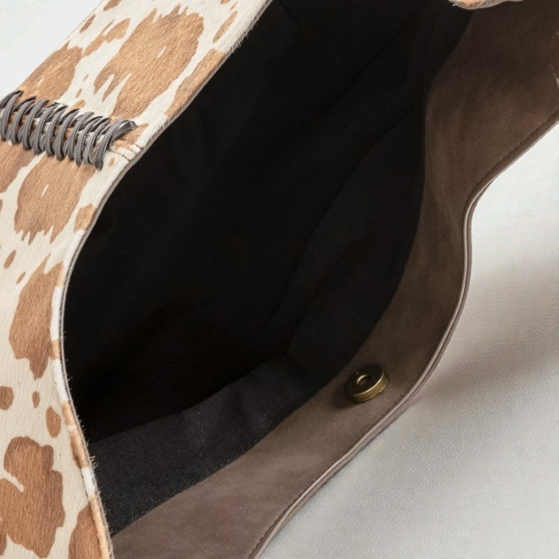 Close-up of a patterned clutch bag with a textured surface.