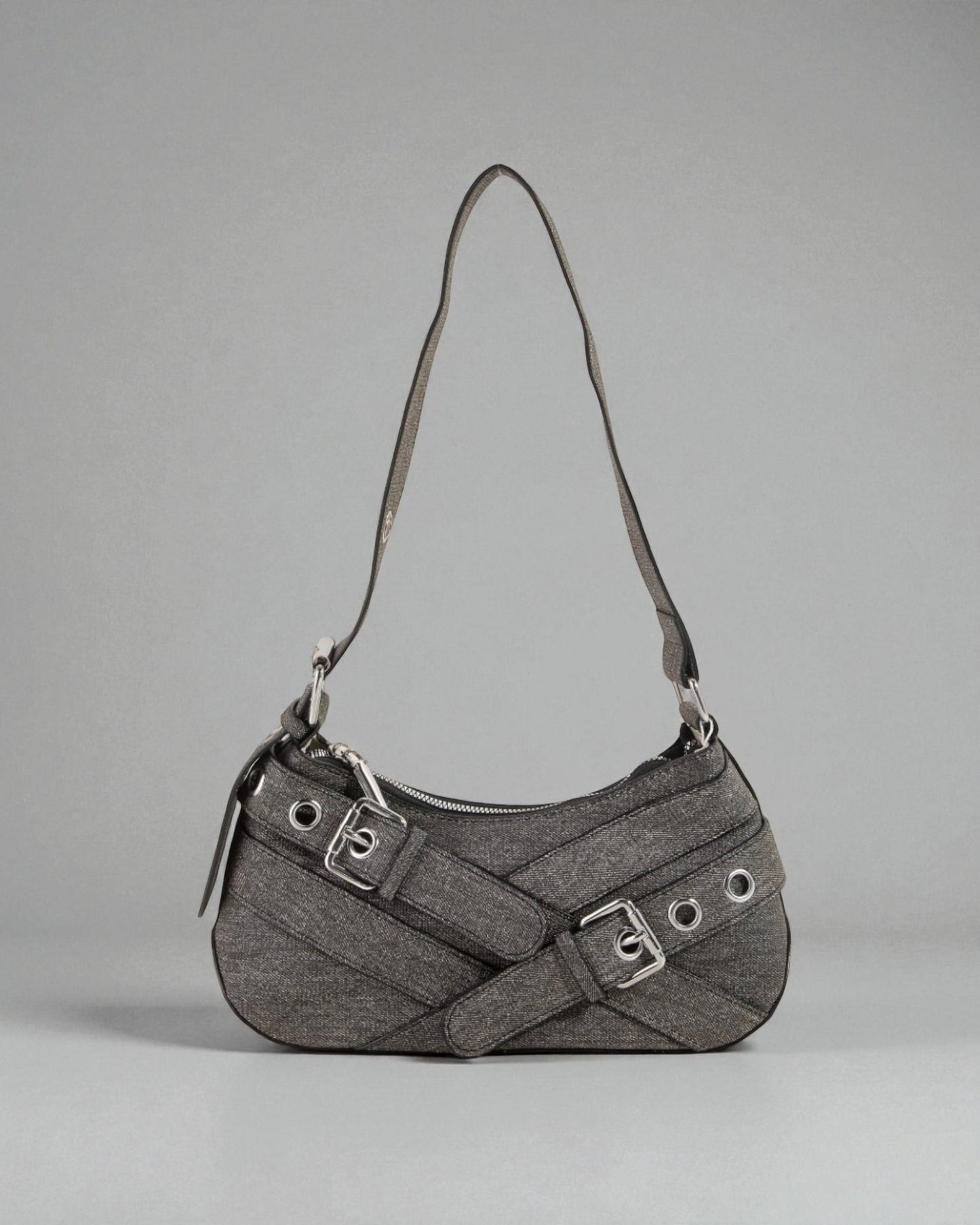 Gray handbag with a strap on a gray background