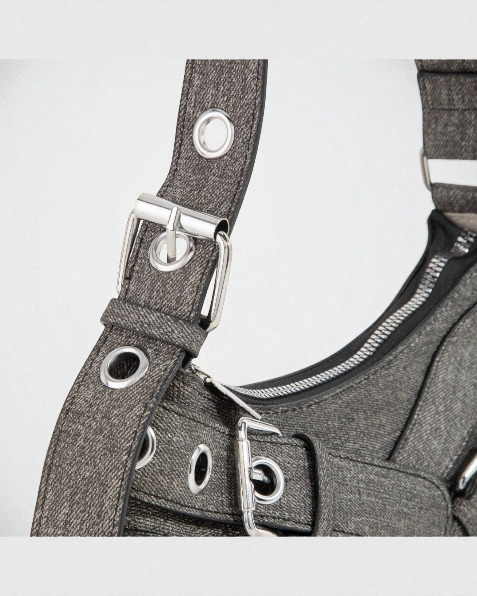 Gray harness with metal buckles on a white background