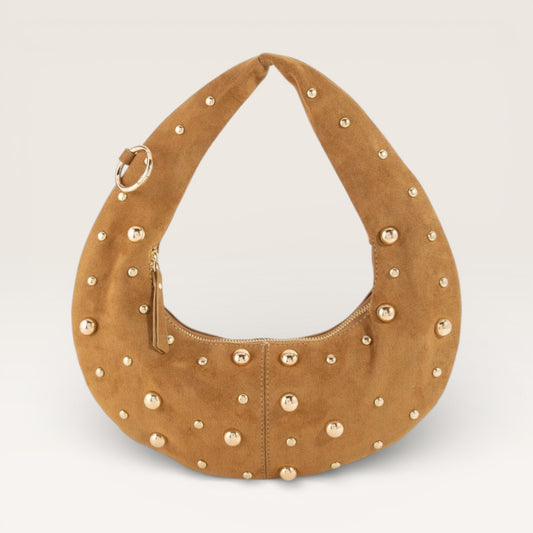 Brown suede handbag with gold studs on a light gray background