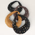 Three studded handbags in black, brown, and gold on a white background