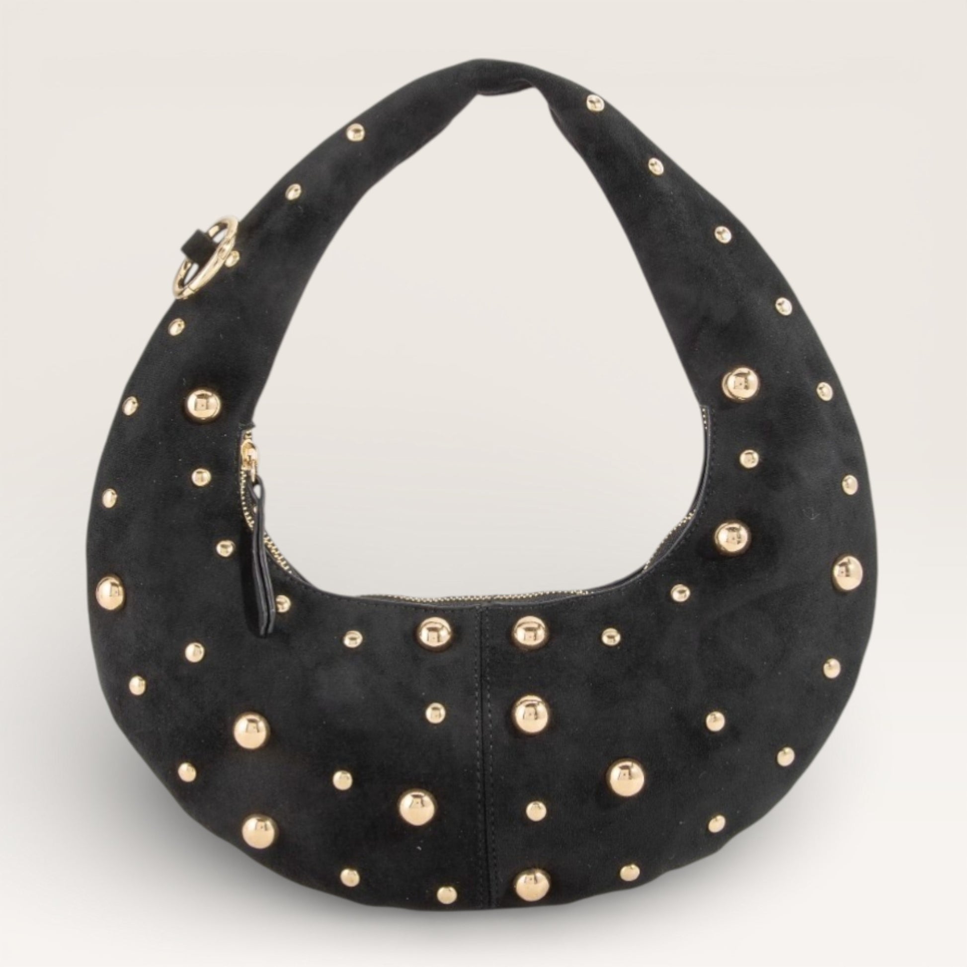 Black handbag with gold studs on a light gray background
