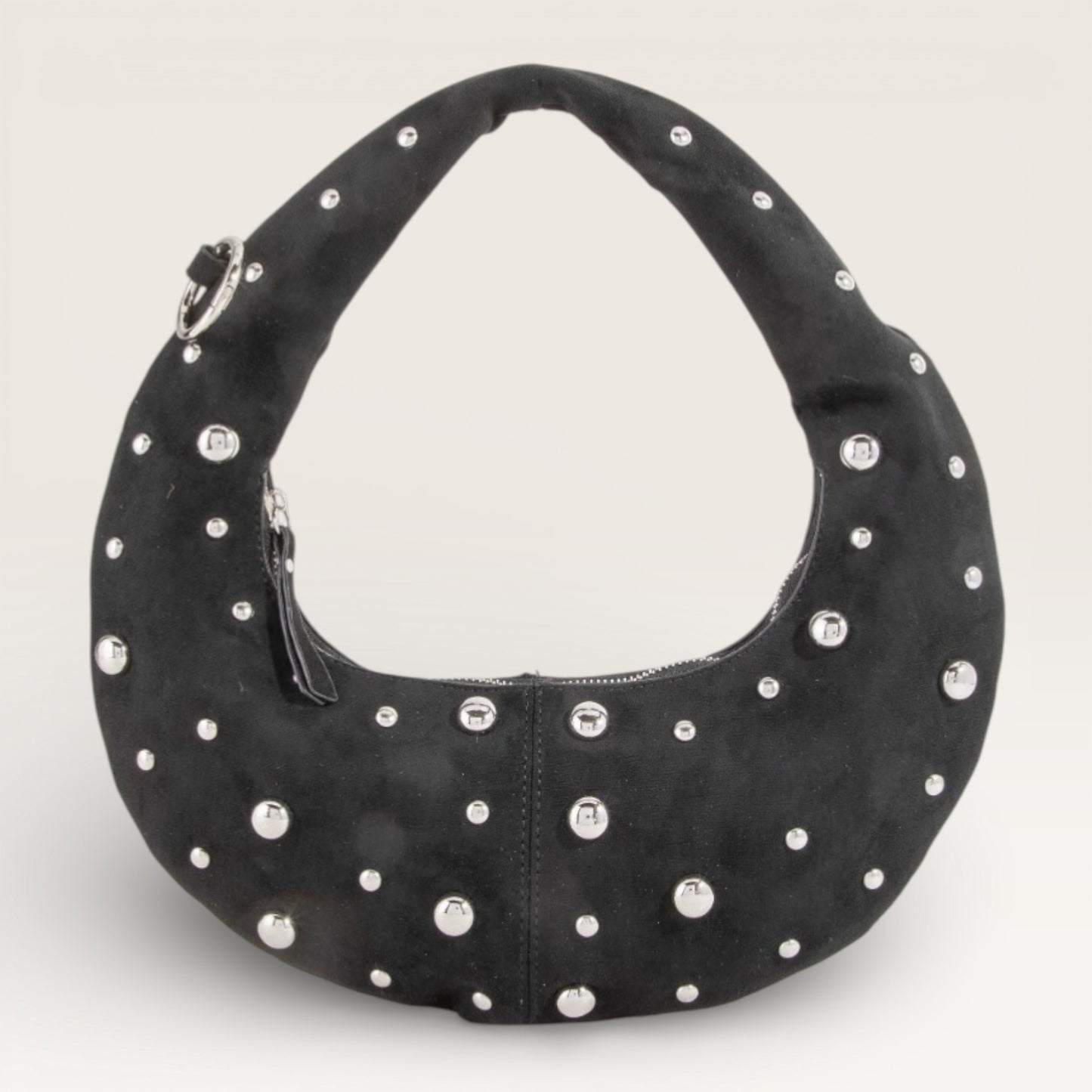 Black handbag with silver studs on a light gray background