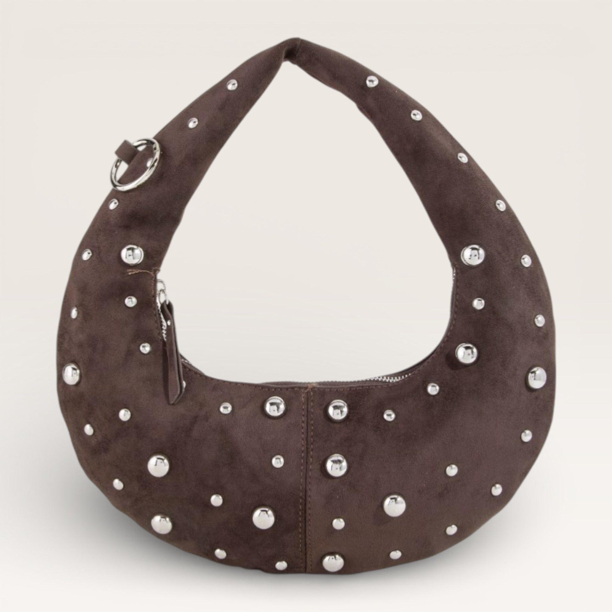 Brown handbag with silver studs on a light gray background