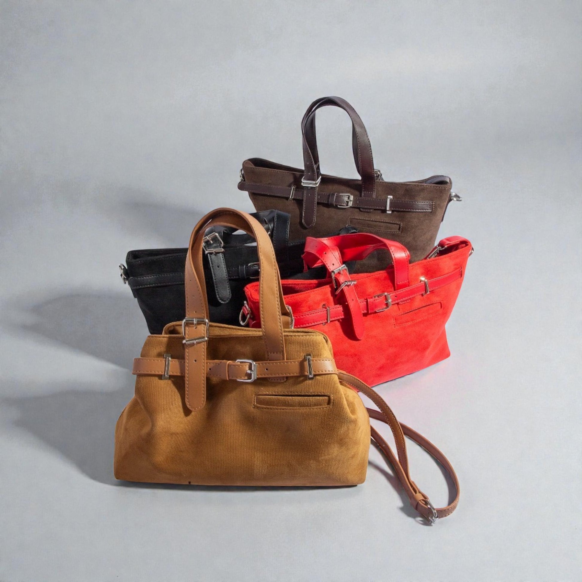 Four handbags in brown, black, red, and tan on a gray background