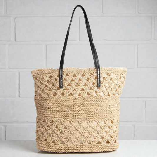 Woven tote bag with black handles on a light gray background