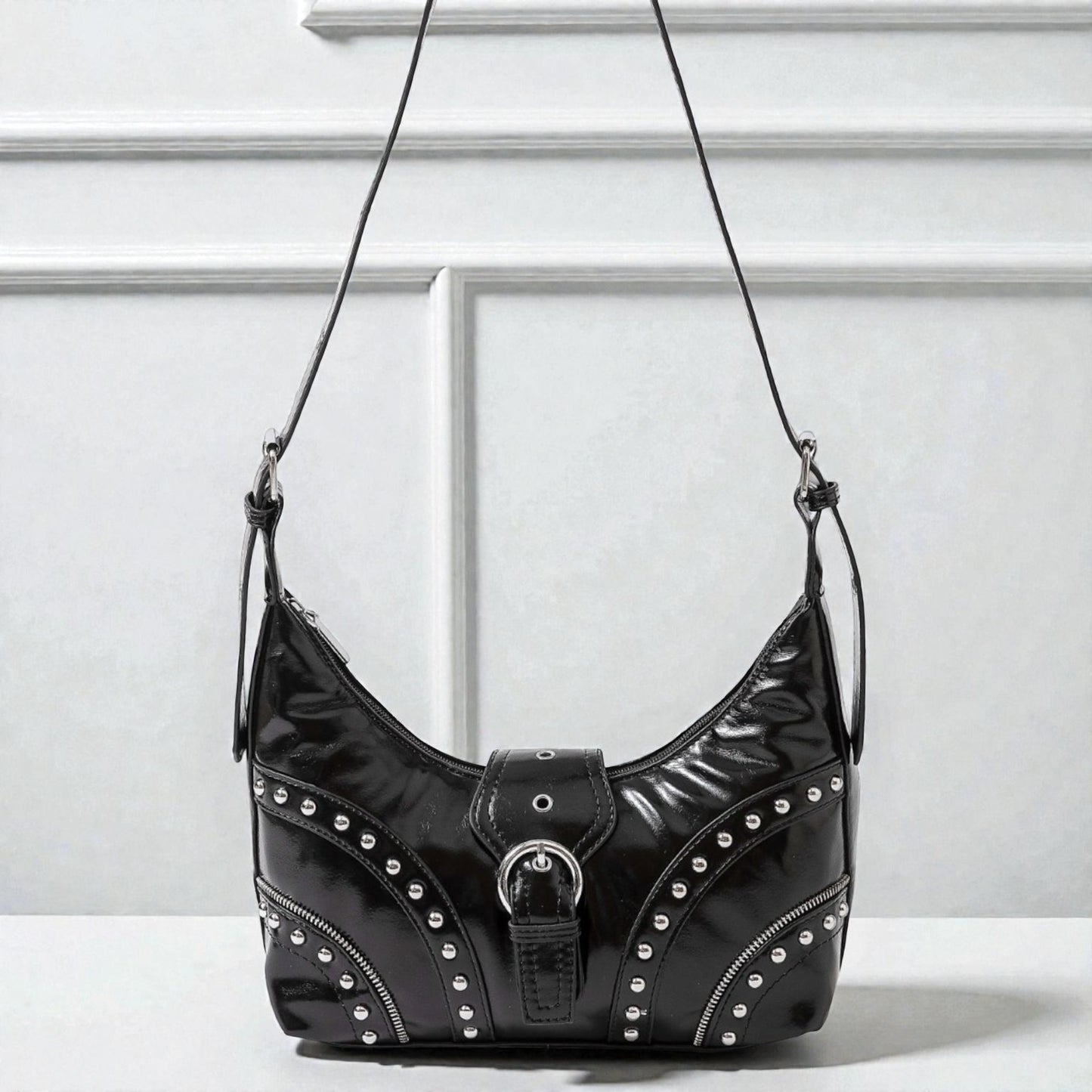 Black studded handbag on a white background