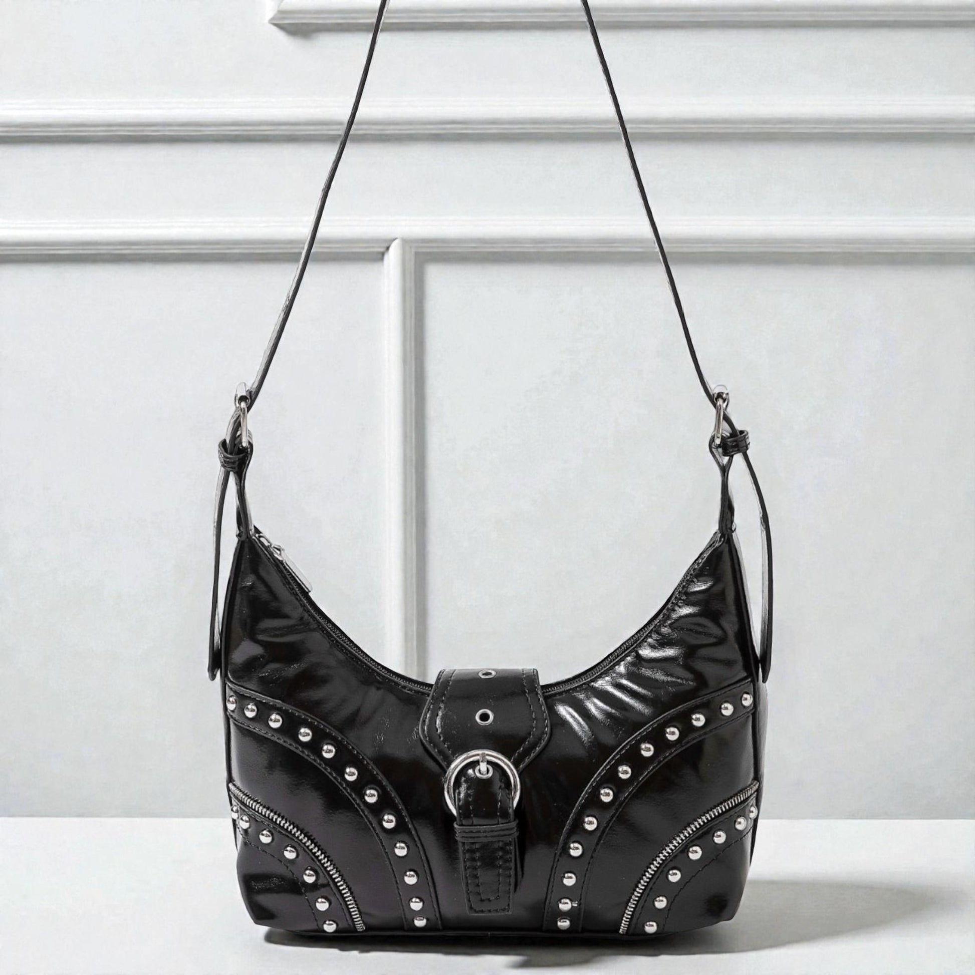 Black studded handbag on a white background
