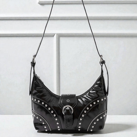 Black studded handbag on a white background