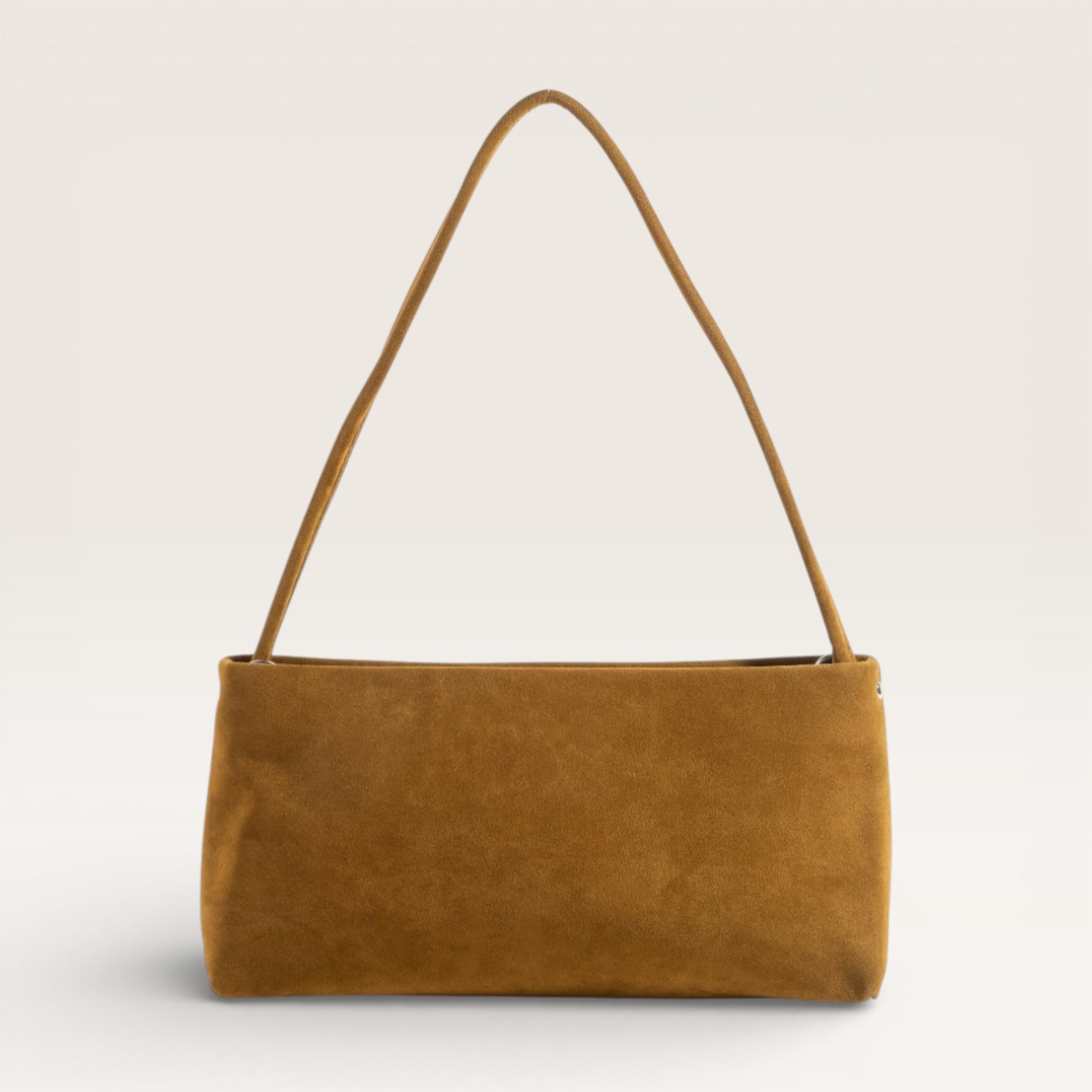 Brown suede handbag on a light gray background