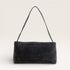 Black suede handbag with a strap on a light gray background