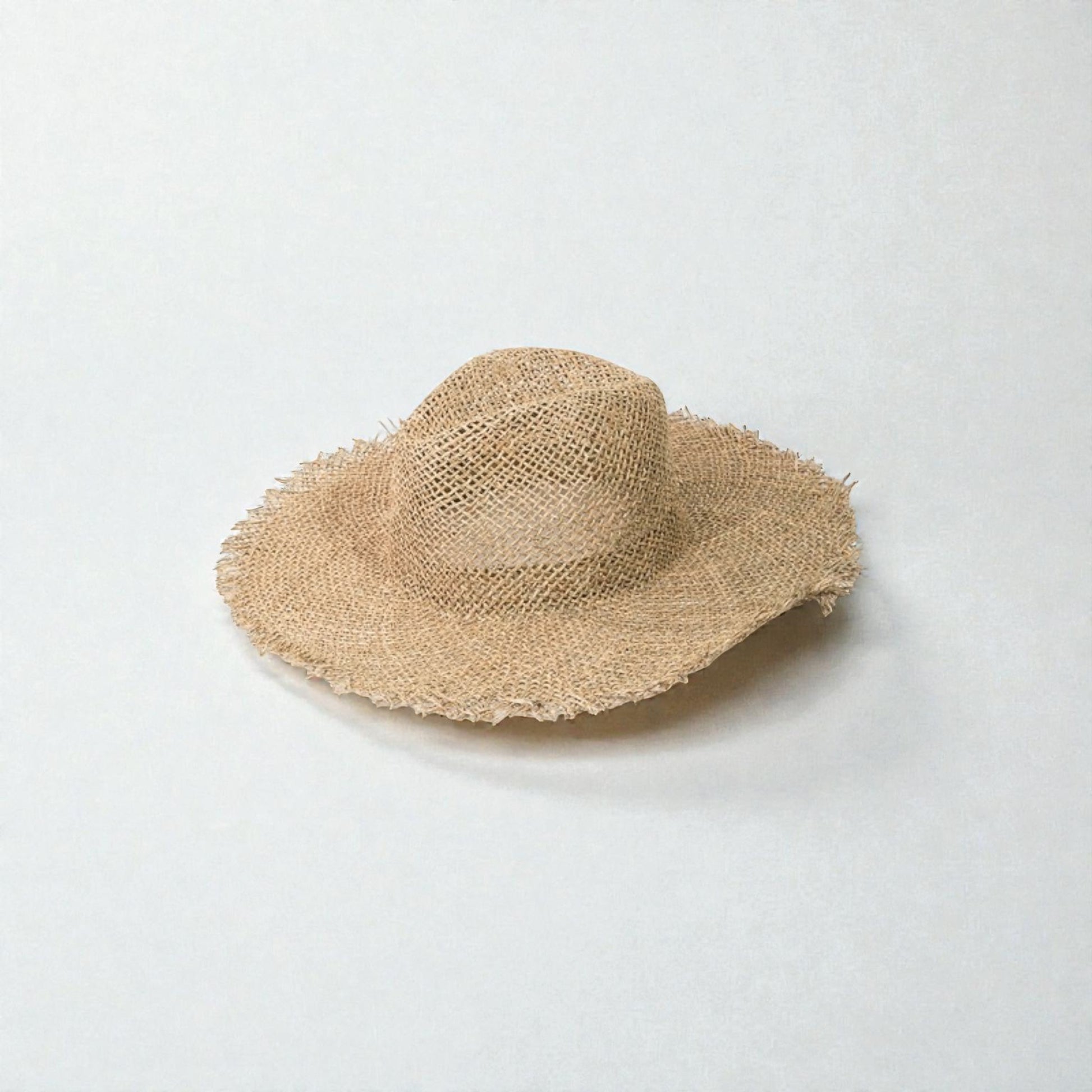 Beige straw hat on a light gray background