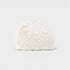 Pearl-handled clutch bag on a light gray background