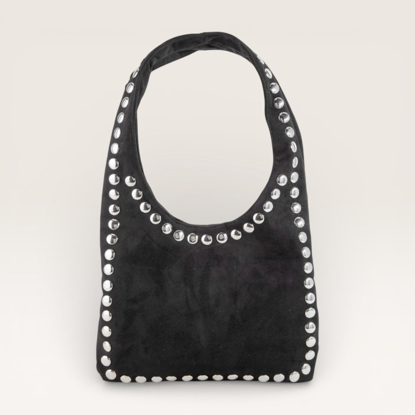 Black handbag with silver studs on a light gray background