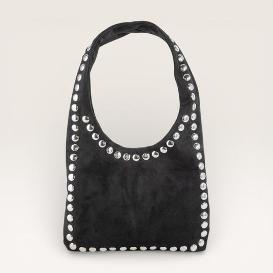 Black handbag with silver studs on a light gray background