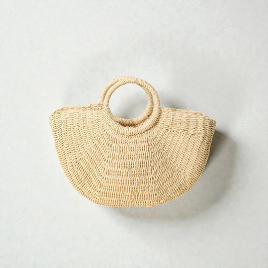 Woven handbag with circular handle on a light gray background