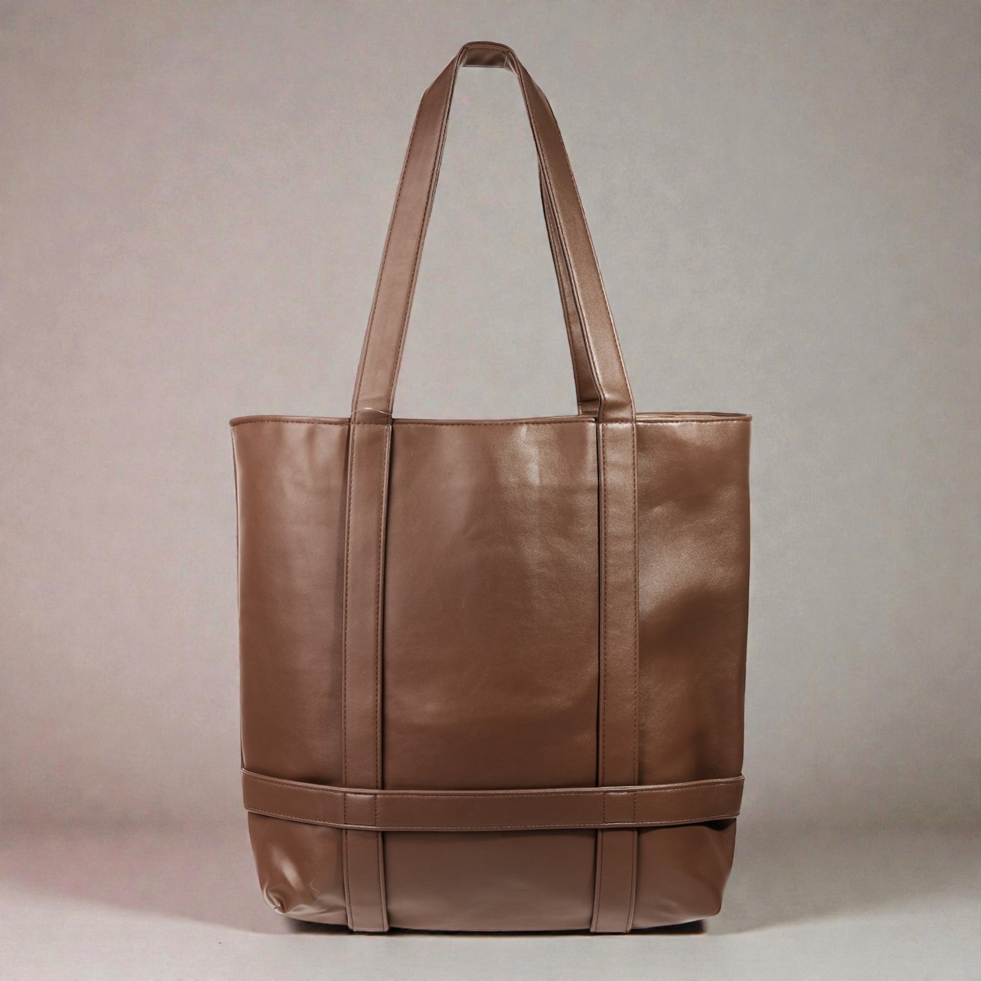 Brown leather tote bag on a beige background