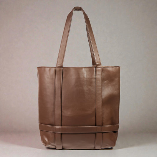 Brown leather tote bag on a beige background