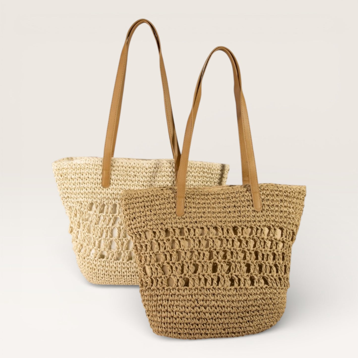 Woven straw tote bag with brown handles on a light gray background