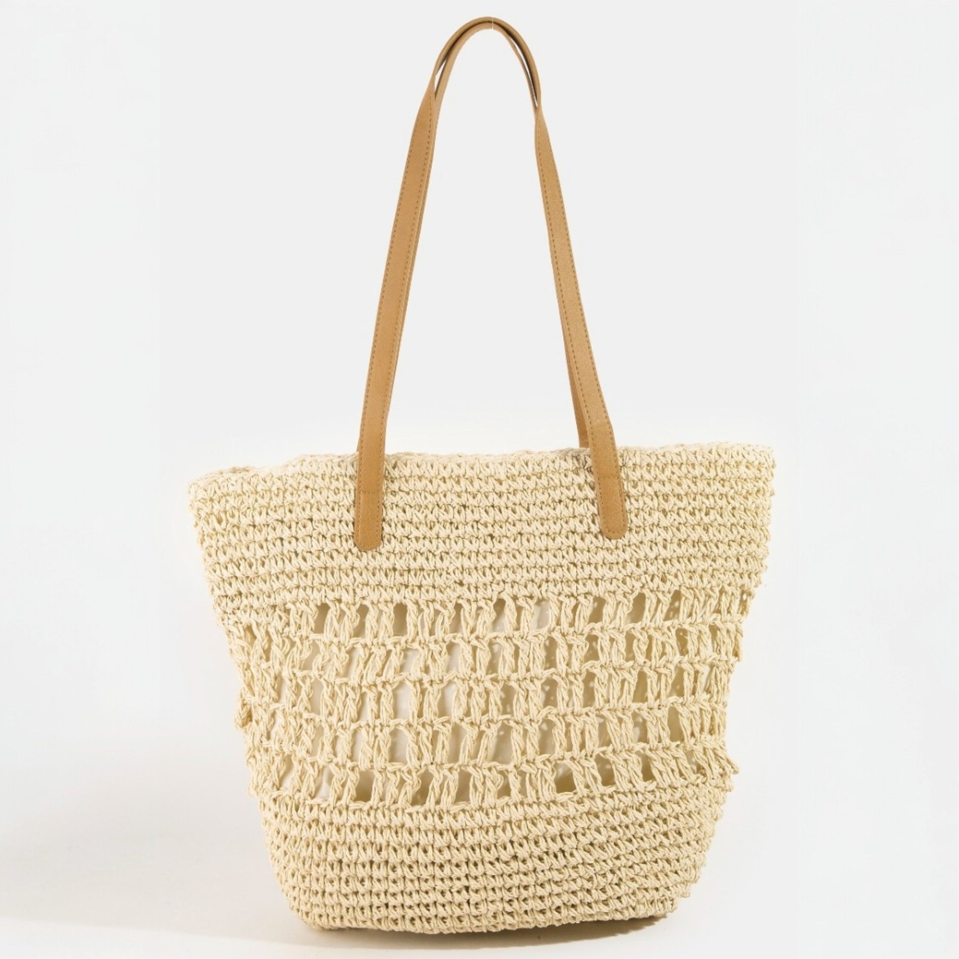 Woven straw tote bag with tan handle on a white background
