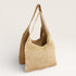 Woven straw bag on a light beige background
