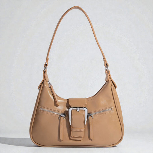 Tan handbag with a silver buckle on a light gray background