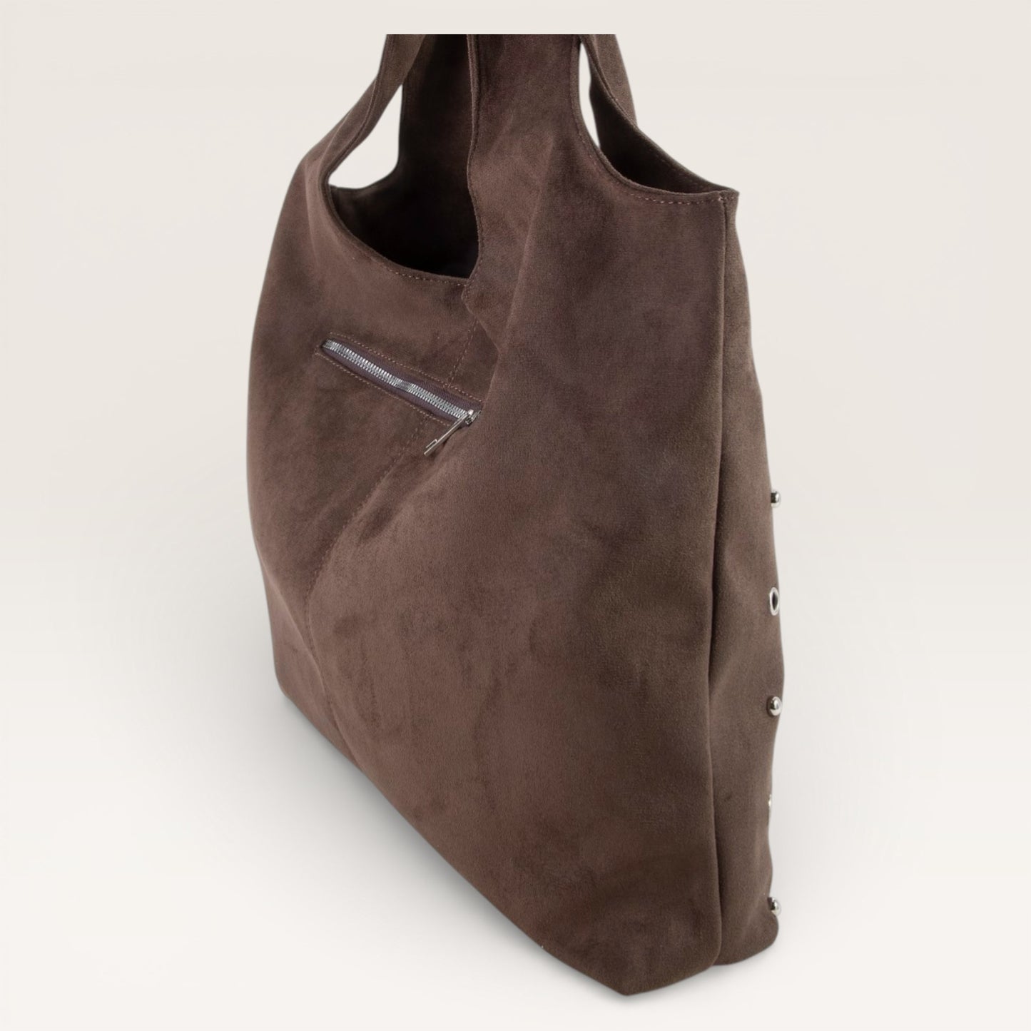 Brown suede handbag on a light gray background