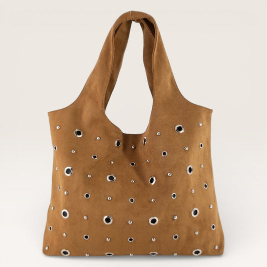 Brown tote bag with decorative studs on a beige background