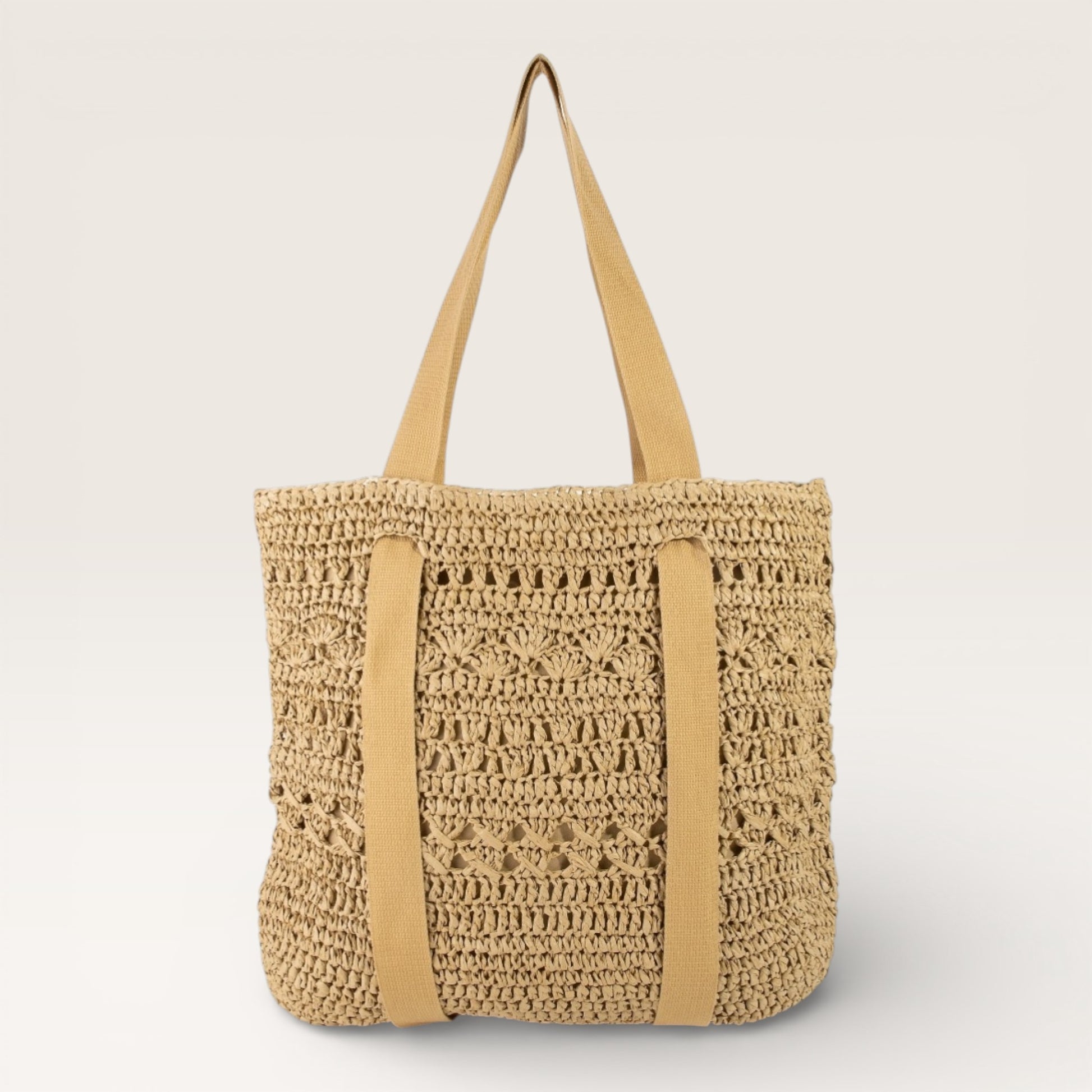 Beige woven tote bag with tan straps on a light gray background