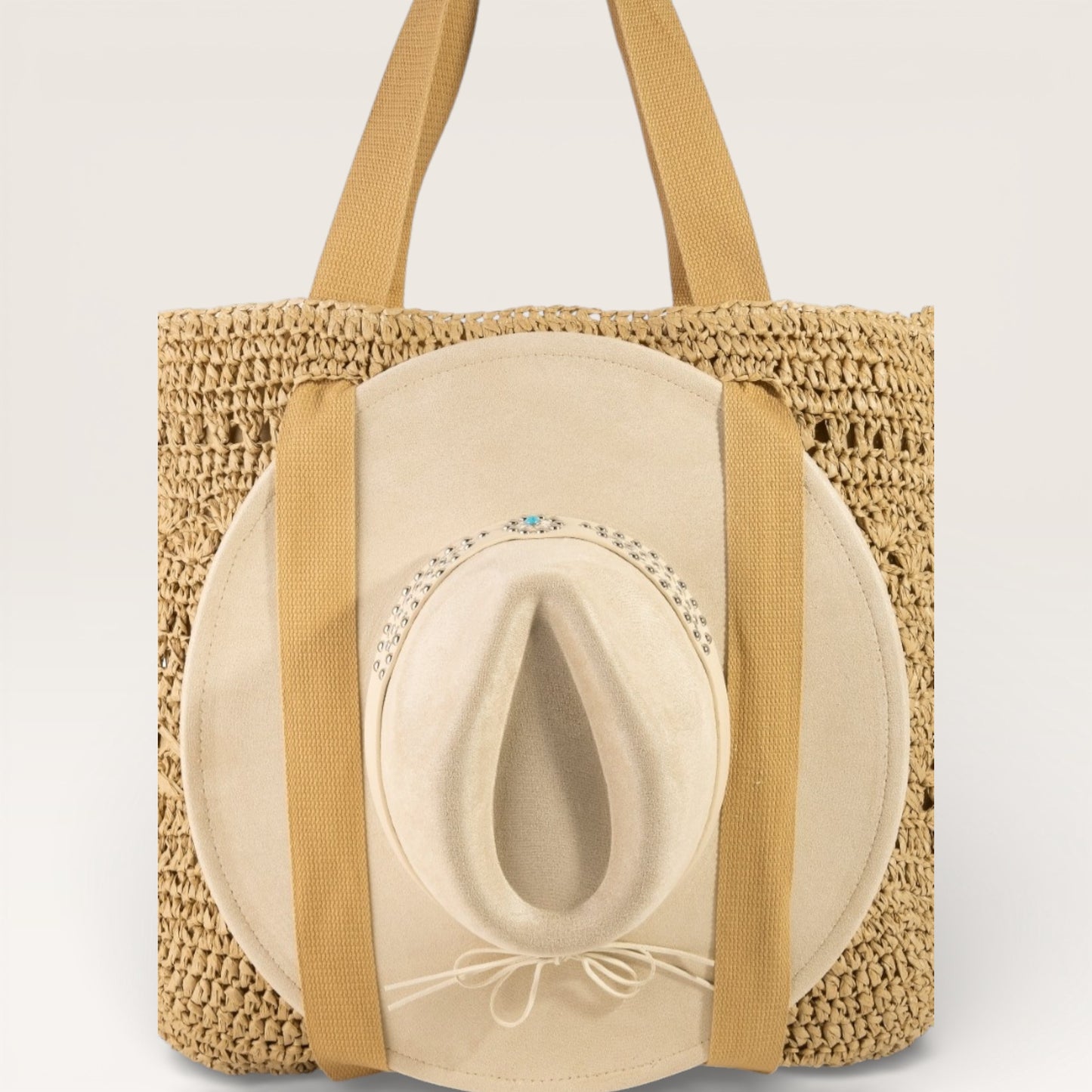 Woven tote bag with a straw hat on a light gray background