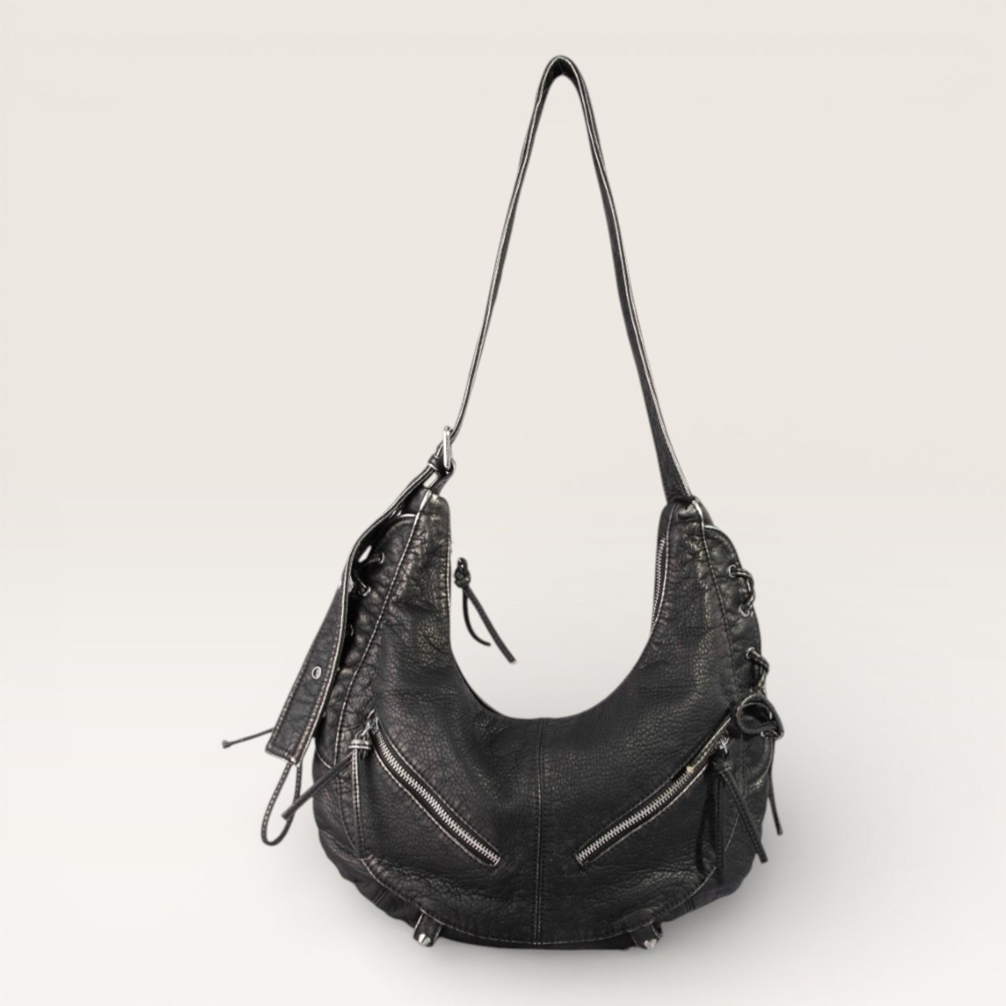 Black leather handbag on a light gray background