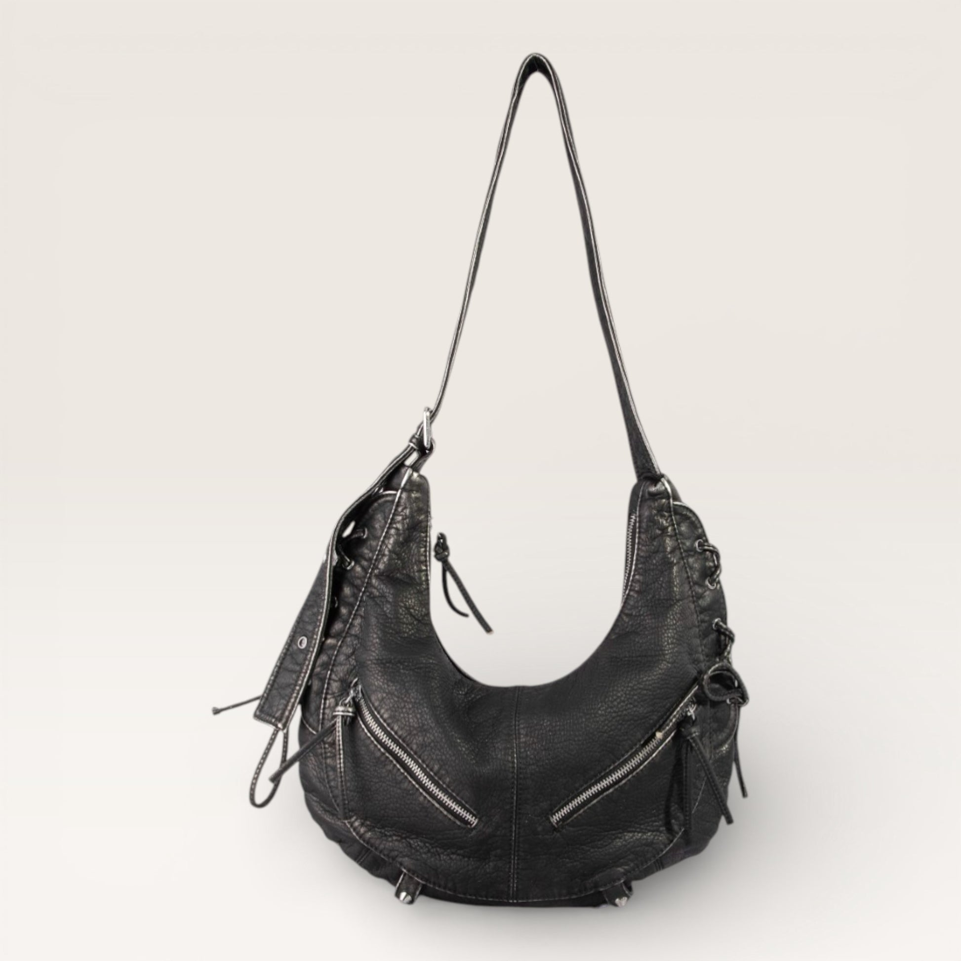Black leather handbag on a light gray background