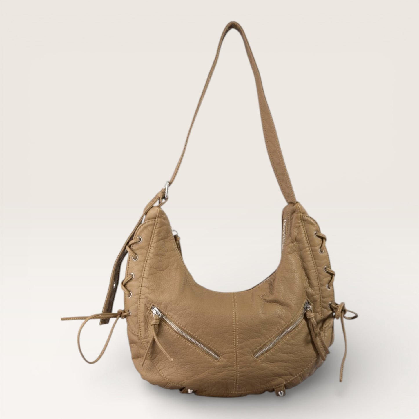 Brown leather handbag with drawstrings on a light gray background
