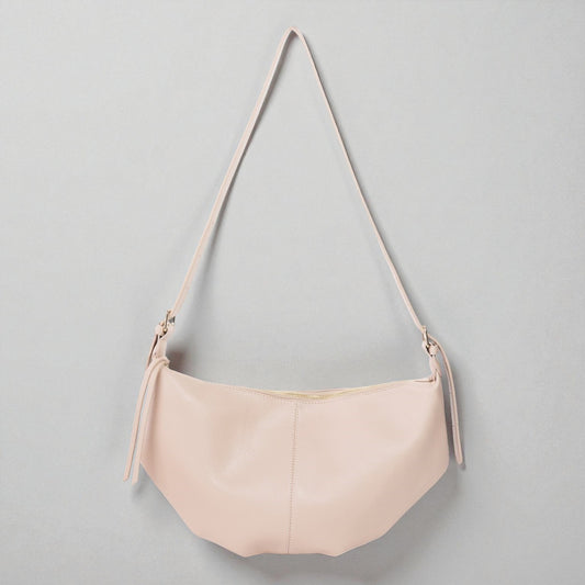 Pink handbag with a strap on a gray background