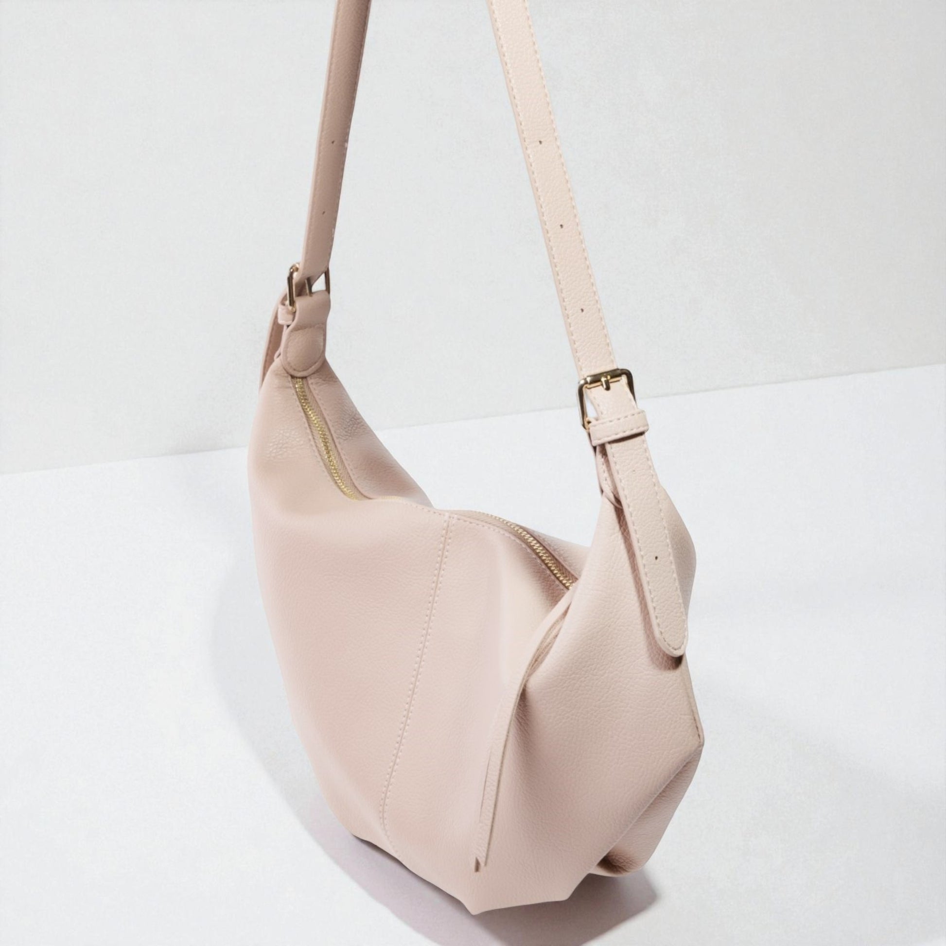 Beige handbag with a strap on a white background