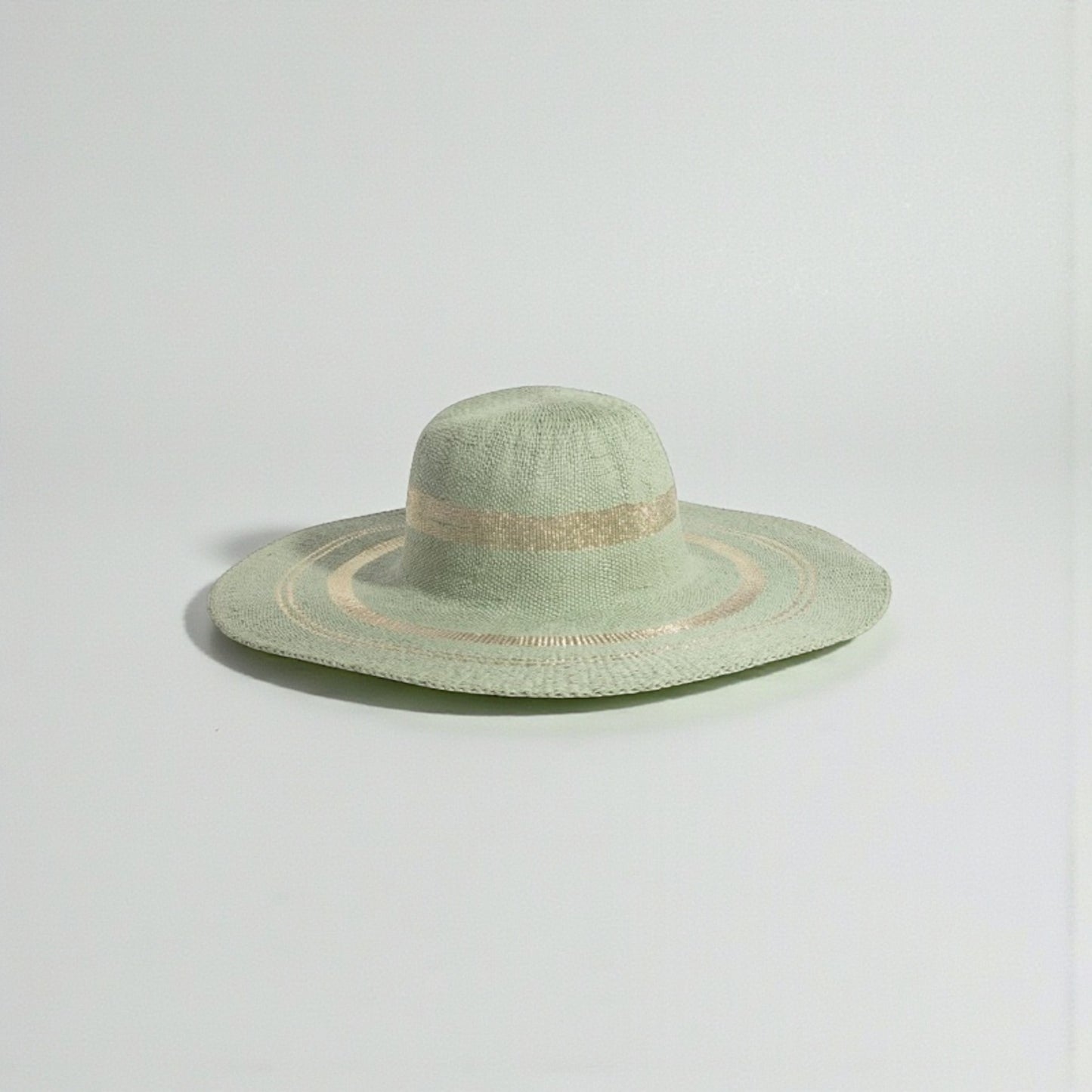 Green sun hat on a light gray background
